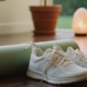 A yoga mat and sneakers in a bright room, showing a mindful way to build strength with a home workout routine.