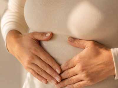 Breathing and pelvic floor after 40 — hands resting on lower ribcage — how diaphragmatic breathing affects pelvic floor coordination in midlife women