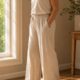 Pelvic floor and belly bulge after 40 — woman's midsection in cream top — how deep core coordination affects abdominal appearance in midlife women