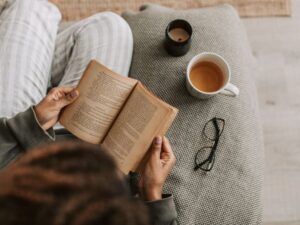 Stress or urgency incontinence — woman reading with tea and candlelight in a cozy moment — understanding the difference between two common patterns