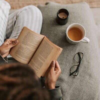 Stress or urgency incontinence — woman reading with tea and candlelight in a cozy moment — understanding the difference between two common patterns