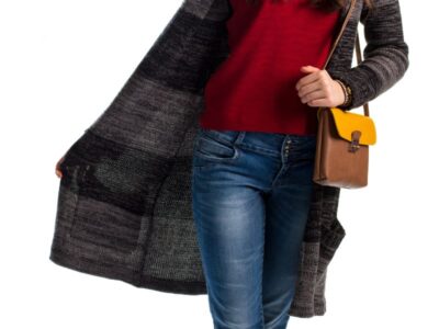 Wearing dark pants just in case — woman in jeans and a cardigan choosing an outfit — the common clothing habit tied to pelvic floor symptoms