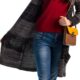 Wearing dark pants just in case — woman in jeans and a cardigan choosing an outfit — the common clothing habit tied to pelvic floor symptoms