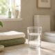 Bright modern bathroom with a glass of water, folded towels, and a potted plant on a marble countertop, symbolizing bladder health and hydration.