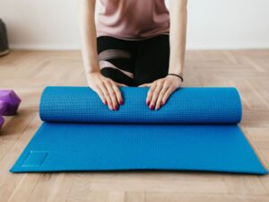 Bladder control exercises for women — yoga mat, water glass, and towel by a sunny window